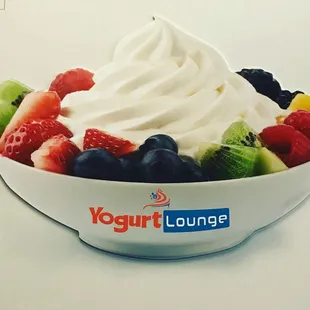 a bowl of fruit and whipped cream