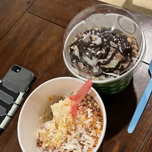 two bowls of yogurt and a phone