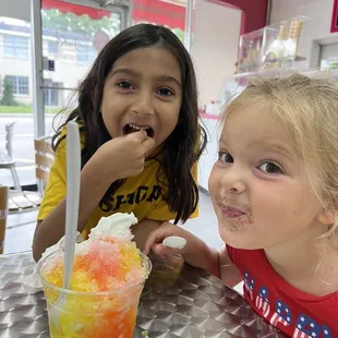 two young girls sitting at a table