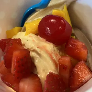 Pumpkin, peanut butter, and chocolate frozen yogurt with mango, strawberries, and a cherry on top!