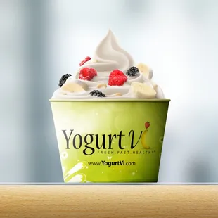 a cup of yogurt with whipped cream and berries