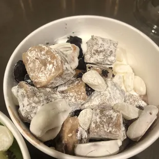 Vanilla and chocolate froyo with cookie dough, white chocolate dipped retzels, mochi, brownie bites, and Reese&apos;s cups (big chunks).