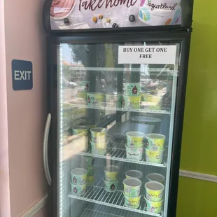 Refrigerator filled with frozen yogurt saying it is "Buy One Get One Free."