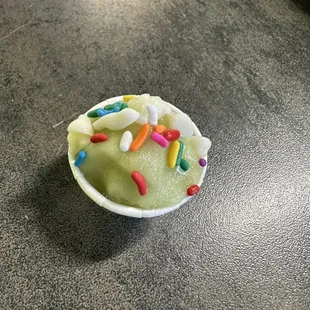 Green apple with rainbow sprinkles