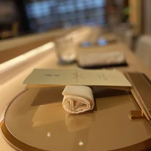 a plate with a napkin and chopsticks on it