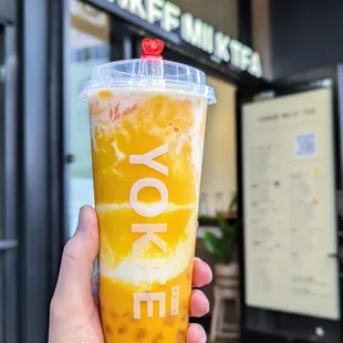 a hand holding a drink