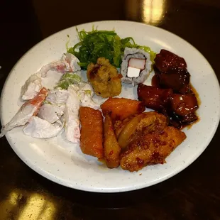 Seaweed Salad, Sushi, Bourbon Chicken, Mala Chicken, Honey Chicken, And Cold Seafood Salad.