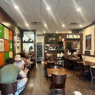 people sitting at tables in a restaurant
