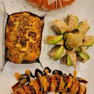 a plate of sushi and vegetables