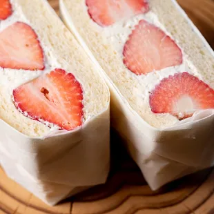 two slices of cake with strawberries on top