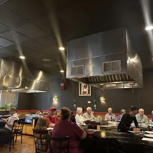 a large group of people sitting at a table