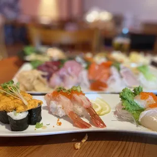 a variety of sushi on a white plate