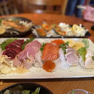 a variety of sushi on a white plate