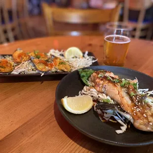 two plates of food and a glass of beer