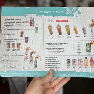 a hand holding a menu