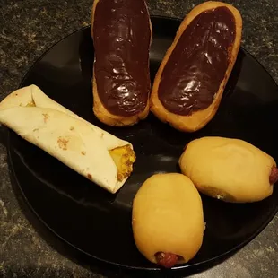 a plate of donuts with chocolate on them