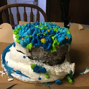 Side of birthday cake. Review posted to explain photo. The owner/manager blamed this fiasco on my driving/Corpus Christi roads.