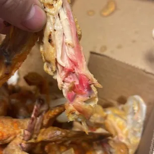 a person picking up a piece of food from a box