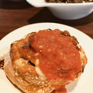 Yoli roll topped with Sunday sauce.