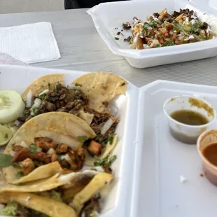 Assorted tacos and Asada Fries with horchata