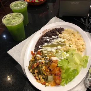 Butter rice, black beans, potatoes and vegetables with spinach and pineapple agua fresca