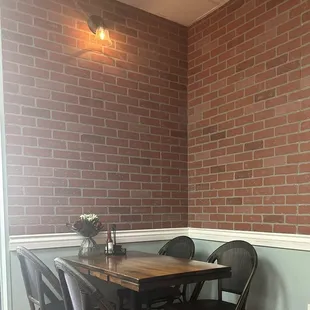 Cute indoor seating with fresh flowers.