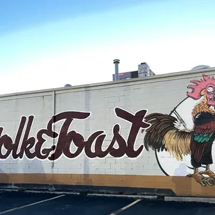 a rooster painted on the side of a building
