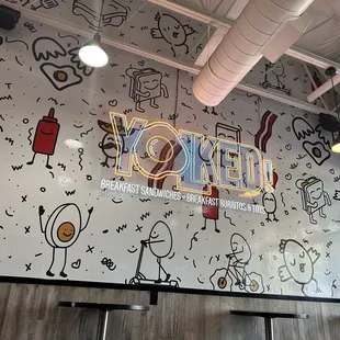 a wall with a variety of drawings on it