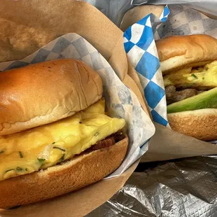 two sandwiches with cheese and an avocado