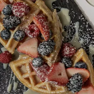 a waffle with strawberries and blueberries
