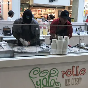 two men working behind a counter