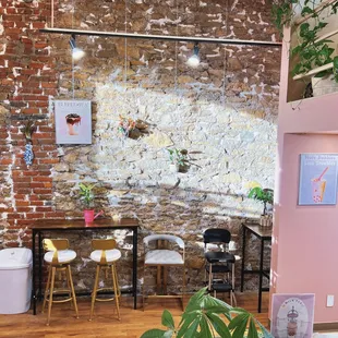 a brick wall and a table and chairs