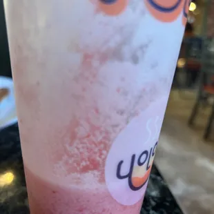 a glass of yol tea with a sticker on it