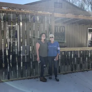 A hanging wall made up of wine nottles