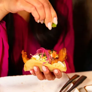 a woman eating a taco