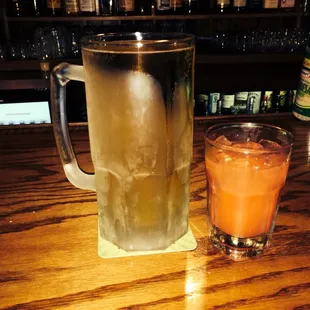 a pitcher of iced tea and a glass of orange juice