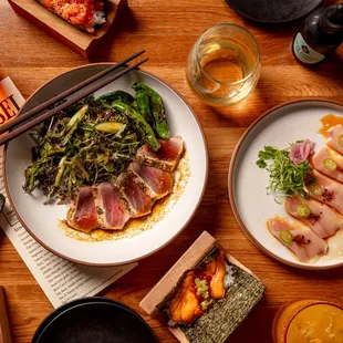 TUNA TATAKI - Mustard greens, cilantro-soy dressing, shishito, lotus root

HAMACHI CARPACCIO - Serrano pepper, fennel oil, ponzu, cilantro