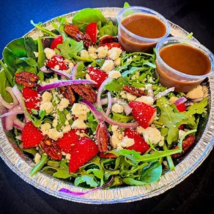 Spinach &amp; Feta salad- Spinach, arugula, red onion, strawberries, sweet &amp; spicy pecans &amp; fetas cheese. Served with house-made balsamic drz.