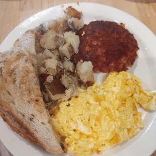 Eggs corn beef hash potatoes and rye toast