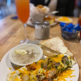 Fiesta chicken, omelette, grits, and toast