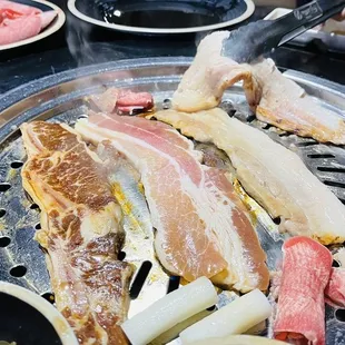a variety of meats on a grill