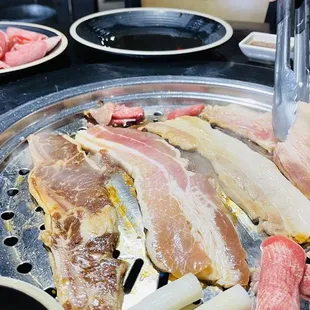 a variety of meats on a grill