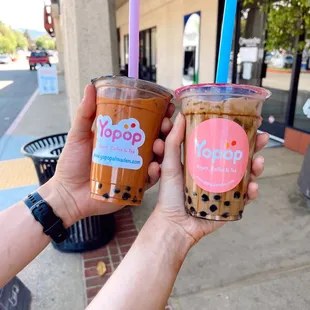 two people holding up their drinks