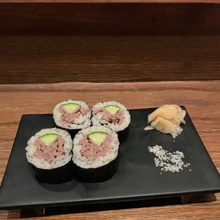 a plate of sushi and a piece of tuna
