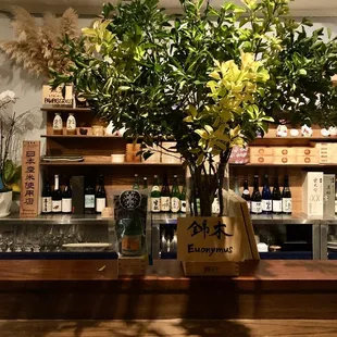 a vase of flowers on a bar counter