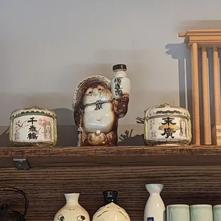 a shelf with various vases and jars