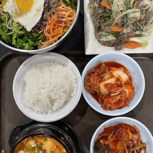 Bibim Bap (top left), Japchae Bap (top right), and Soon Du Boo Bak Ban with rice and kimchi (bottom)