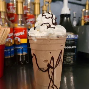 a cup of coffee with whipped cream and chocolate