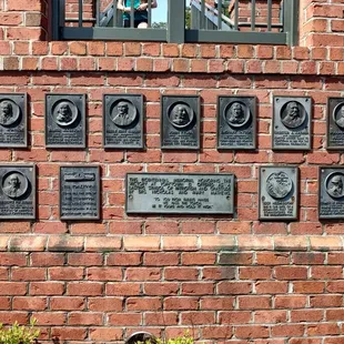 a brick wall with plaques