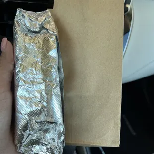 a hand holding a foil wrap